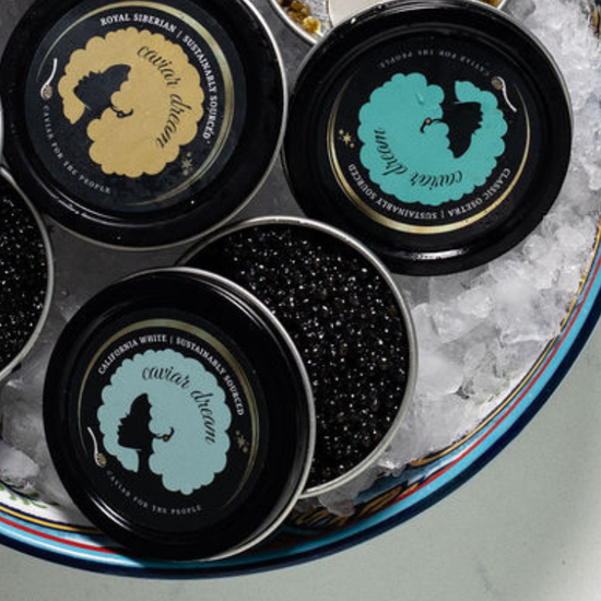 Open Caviar Dream tins in a bowl of ice