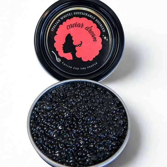 Open container of Italian White caviar with a branded lid on a white background