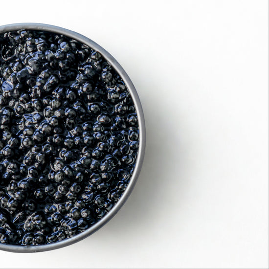 Open tin of caviar on a white background