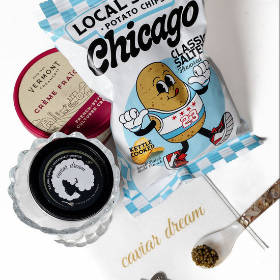 Packaged potato chips with a decorative napkin and Kaluga Hybrid caviar on a white background