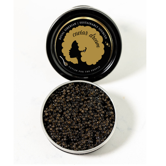 Open container of Royal Siberian caviar with 'Caviar Dream' branding on a white background. Dark brown to light black roe.