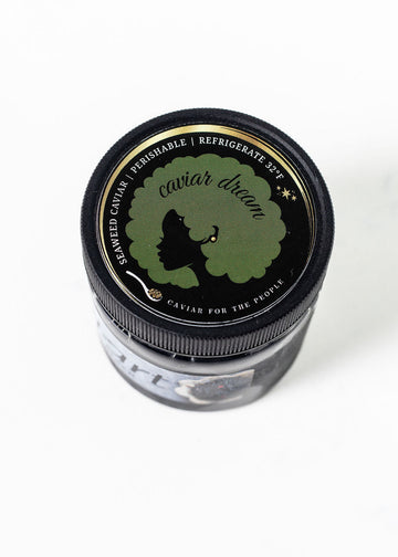 Small jar of "seaweed" caviar with a black lid featuring Caviar Dream branding on a white background