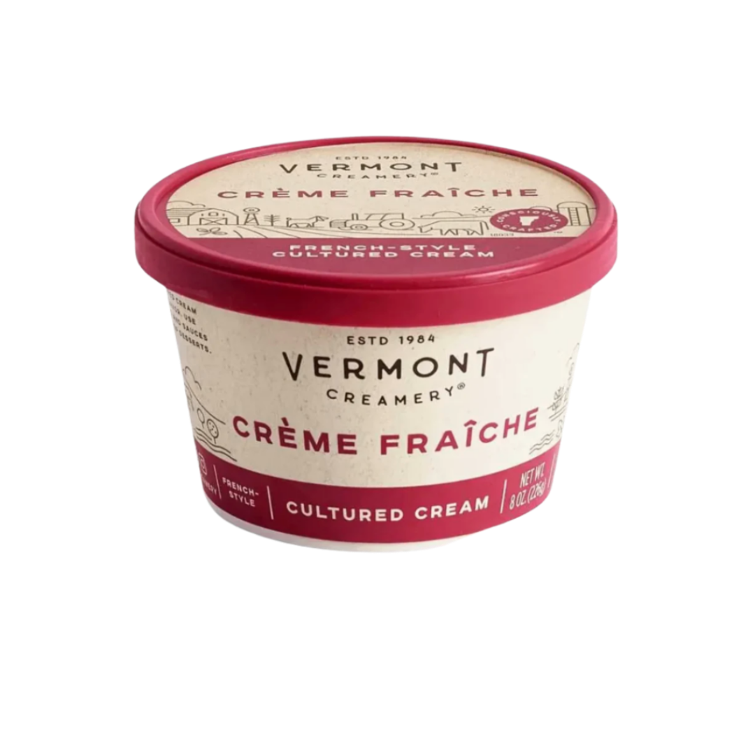 A tub of Vermont Creamery Crème Fraîche (Fresh Cream) on a plain white background. The packaging features a cream-colored label with dark red accents and a matching dark red lid.