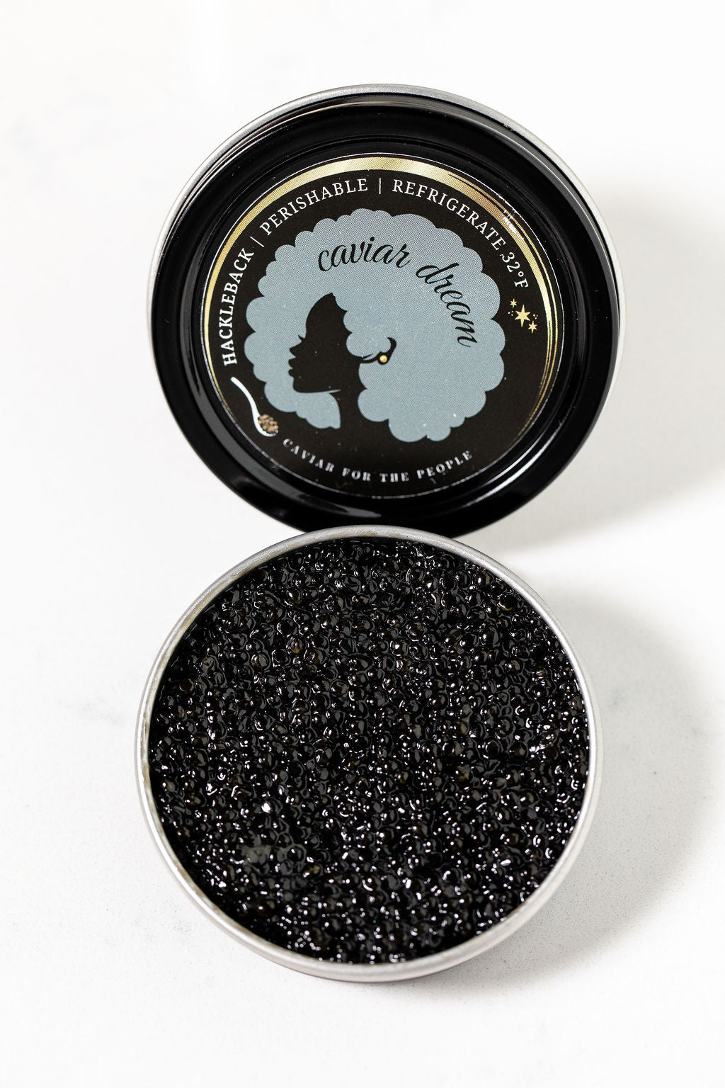 Caviar Dream Hackleback caviar tin open to display luscious black caviar